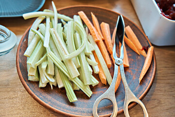 Celery and carrot sticks on a plate in a self-service restaurant. Diet and healthy snack. Healthy...