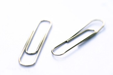 Metal clip. Minimalism office paper clip for important documents and files. White background, isolation.