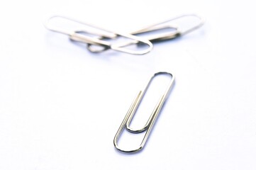Metal clip. Minimalism office paper clip for important documents and files. White background, isolation.