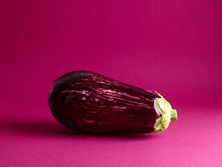 ripe eggplants over magenta background