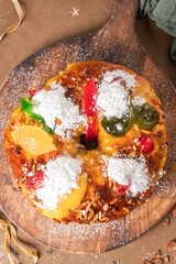 Bolo do Rei or King s Cake, Made for Christmas, Carnavale or Mardi Gras with Christmas season elements in Background.