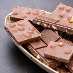 Chocolate cupcake with icing and chocolate bar in Dark lighting,Homemade delicious chocolate muffin on wooden background close-up