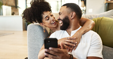 Couple, hug and laughing for phone in home with social media meme, internet joke and comic notification. People, happy and smartphone in living room with funny web search, bonding or embrace in house