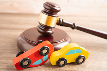 Hammer gavel judge with car vehicle accident, insurance coverage claim lawsuit court case.