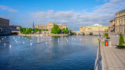 Fototapeta premium A serene view of the House of Parliament in Stockholm, reflected on the waters surface, with a clear blue sky overhead. Stockholm, Sweden