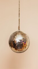 Obraz premium disco ball hanging on chain isolated on pastel beige background