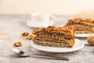 Walnut and hazelnut cake with caramel on brown concrete. side view, selective focus