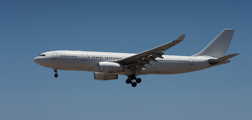 The plane lands.Airplane, passengers flying in the blue sky, preparing to land at the airport
