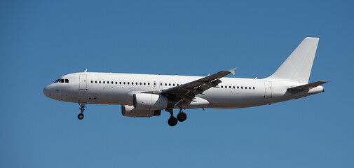 The plane lands.Airplane, passengers flying in the blue sky, preparing to land at the airport