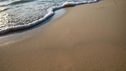 Beach sand background with sea water, summer concept.