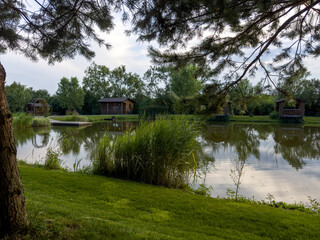 Obraz premium Discover the perfect fishing spot on our serene lake. Enjoy tranquil surroundings, clear waters, and the thrill of the catch. Ideal for a relaxing day in nature with friends and family.