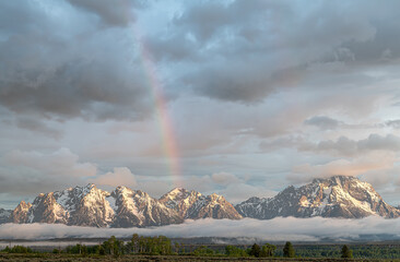 Inversion Clouds and Rainbow at dawn in the Teton Mountains, Grand Teton National Park, Wyoming, USA