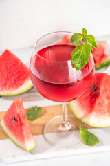 Homemade sweet cold watermelon wine glass with slices of ripe fresh red watermelon and mint leaves