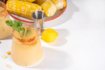 Sweet corn margarita drink, tasty spicy alcohol cocktail with corn, lime and mint, copy space