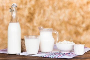 Dairy products on table against the background of hay