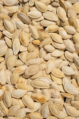 Close-up of unpeeled pumpkin seeds from above.