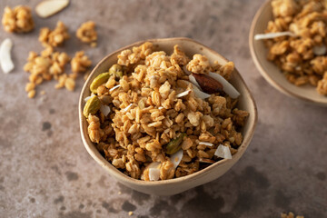 Crispy homemade granola with sliced almonds in a bowl. Healthy food