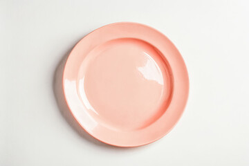 Empty pink plate on a white background