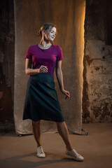 Fototapeta premium Elegant blonde in a medium-length casual dress. photo in dark colors