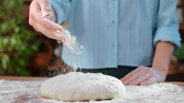 Professional baker pouring dough by multigrain flour in home kitchen, traditional recipe, details