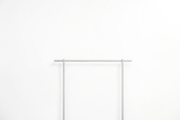 Minimalist Clothes Rack in Front of a White Wall