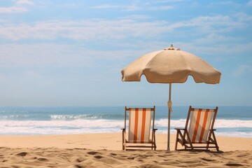 photo of two beach chairs, beach umbrella and surf board on the beach