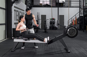 Active couple engaging in a dynamic workout session at the gym.. © chadchai
