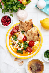 Cilbir or Turkish Eggs in white bowl. Turkish cuisine concept.