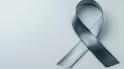 Silver awareness ribbon on light background Symbol of health, cancer, or support
