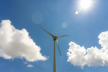 Wind power generator against a cloudy sky.