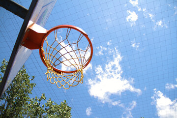 Basketball hoop outdoors with wonderful cloudy sky in background