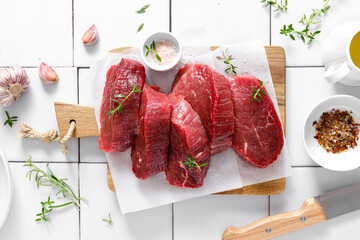 Beef. Raw beef tenderloin meat, beef steaks with ingredients for cooking. Top view