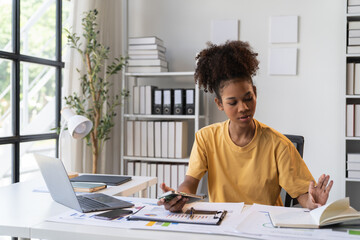 happy young businesswoman African American siting on the chiar cheerful demeanor raise holding coffee cup smiling looking laptop screen.Making opportunities female working successful in the office.	