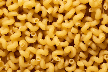 A pile of raw pasta close-up. Italian pasta, pasta cones texture, top view