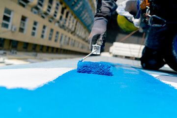 close up on the roof of a high-rise building against the background of multi-colored bright houses...