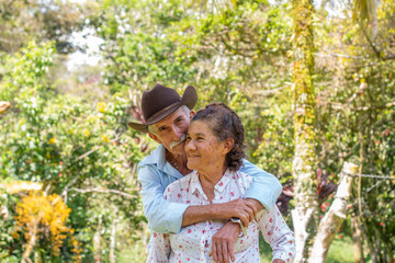 Lifestyle: Elderly husband and wife. husband embraces wife