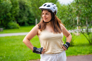 Portrait of roller skater woman in park rollerblading on inline skates. Outdoor activities. Summer...