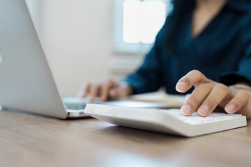 Business woman Remote Work from Home with Laptop and Calculator for Business Productivity