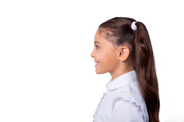 Snap shot, profile side view of nice cute cheerful adorable lovely stylish little small girl with curly ponytails in white formal blouse shirt. Isolated over grey background