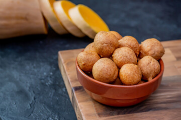 Freshly cooked pumpkin fritters on a table.