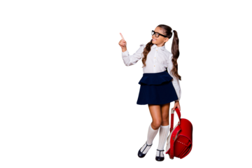Full size body length of glad girlish dreamy nice smart cute small little girl with curly ponytails in white blouse shirt and blue skirt with red bag, pointing finger up. Isolated on black background