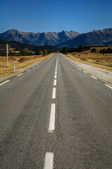 Straight road between La Quillane and Les Angles. In the background, the mountains of the Eastern Pyrenees between Cambredase and Puig de Gallinàs (Pyrénées Orientales, France)