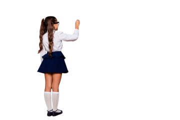 Back rear view of nice genius adorable small little girl with curly ponytails in white formal blouse shirt, short blue skirt, writing on blackboard. Isolated over black background