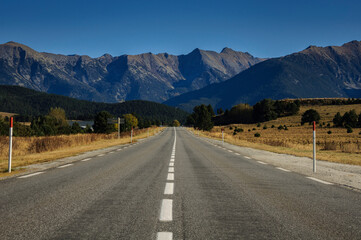 Straight road between La Quillane and Les Angles. In the background, the mountains of the Eastern Pyrenees between Cambredase and Puig de Gallinàs (Pyrénées Orientales, France)