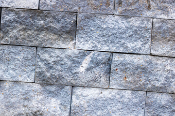 The image shows a detailed view of a brick wall with numerous stains