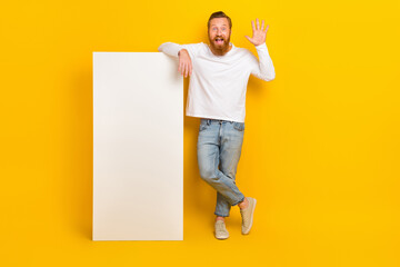 Full body photo of beard man near big telephone wave wear shirt jeans shoes isolated on yellow color background