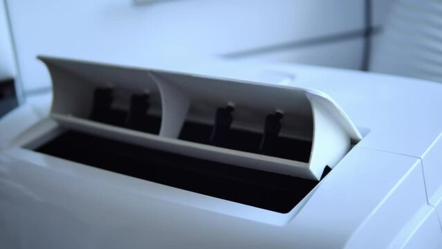 White air conditioner damper moves down and up, regulating airflow. Conditioner adjusts to maintain ideal temperature. The movement of the conditioner damper ensures even cooling throughout room.