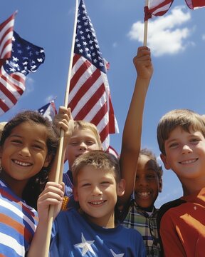 A group of smiling children hold American flags on a sunny day, celebrating a patriotic event.