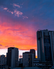 Saburtalo new high rise real estate buildings with dramatic purple orange sky in motion blue hour copy space background. Caucasus modern real estate development sites concept