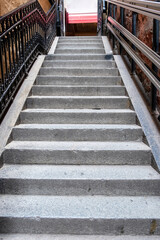 Outdoors stone stair background texture. Empty staircase with metal banister and rail. Vertical